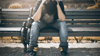 Man sitting depressed on a bench