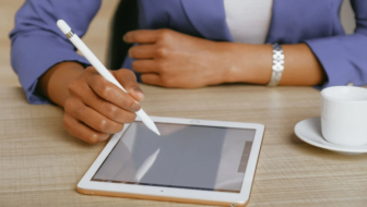 A man jotting down on I-pad.