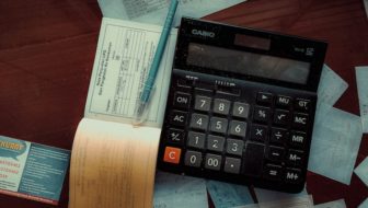 An invoice book and a calculator.