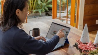 Woman working on laptop.